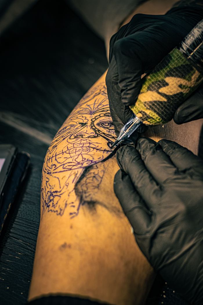 Stencil linework on skin at the start of a blackwork session